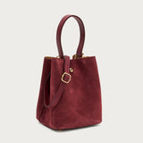 Small burgundy suede bucket bag